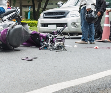 motorcyclist laying on ground after crash